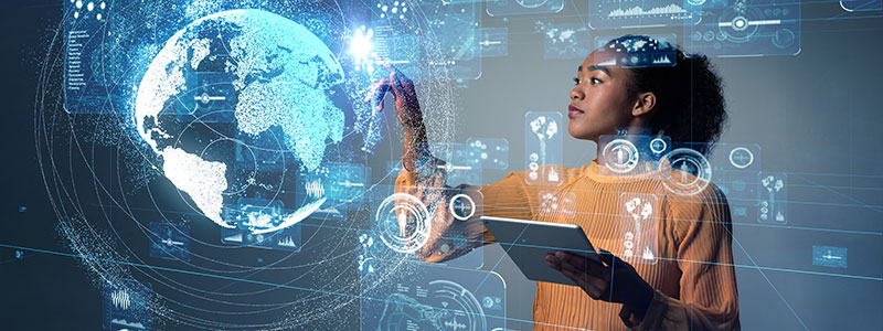 A girl working on a 3D globe with a tablet in her hand.