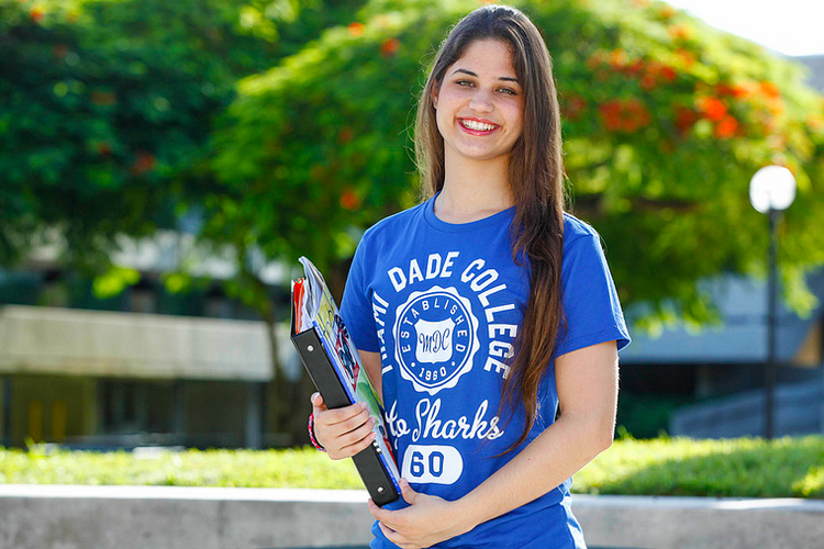 MDC student holding notebooks