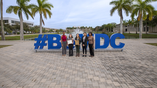 Sea side image of four of the staff members for MDC's 'The Reporter'