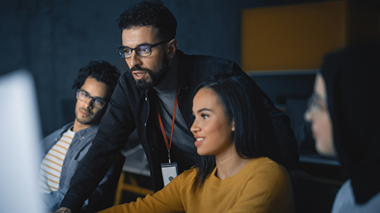 Software Engineers in front of a computer working together